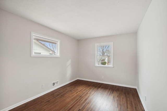 empty room with dark hardwood / wood-style floors