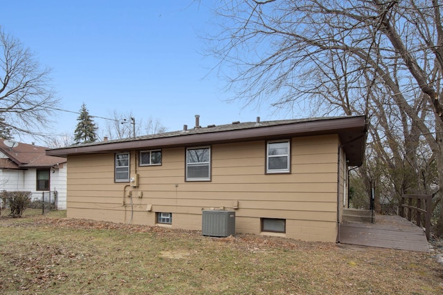 view of property exterior with a yard and central AC unit