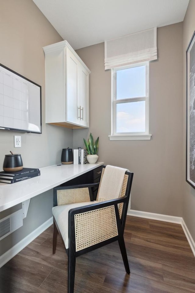 office featuring built in desk and dark wood-type flooring