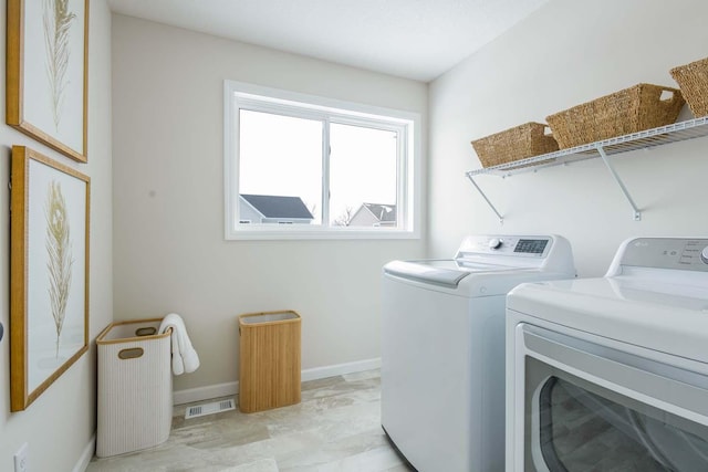 washroom with washing machine and clothes dryer