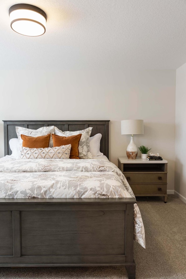 carpeted bedroom featuring a textured ceiling