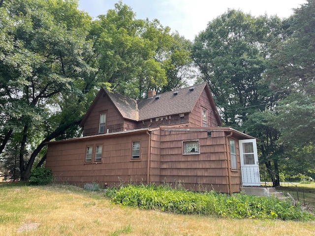 view of side of property with a yard