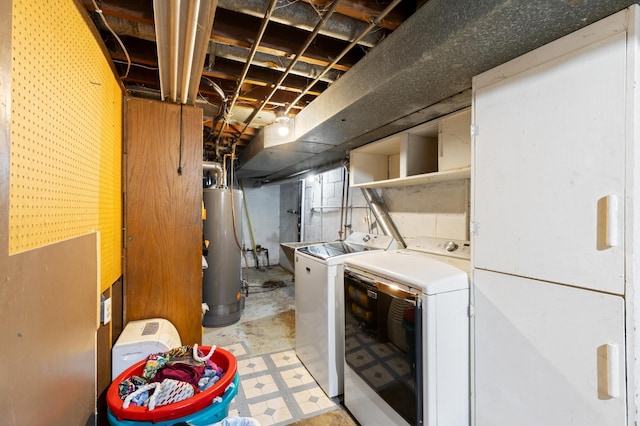 laundry area with gas water heater and separate washer and dryer