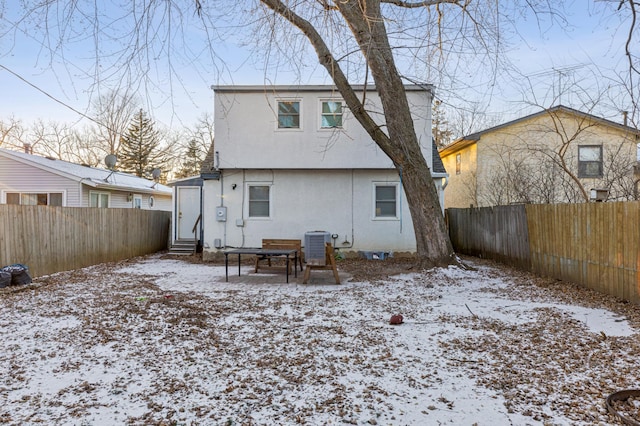 snow covered property featuring cooling unit