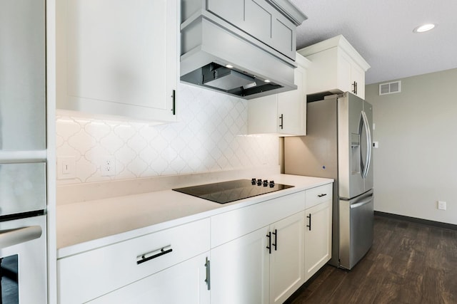 kitchen with stainless steel appliances, custom exhaust hood, dark wood finished floors, light countertops, and decorative backsplash