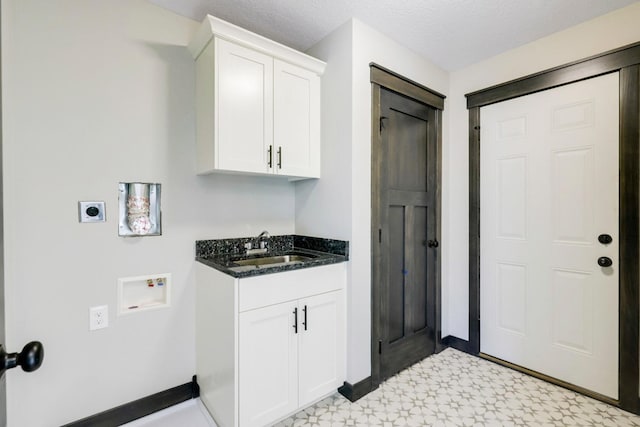 washroom with hookup for an electric dryer, light floors, washer hookup, wet bar, and cabinet space