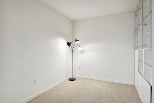 empty room featuring light carpet