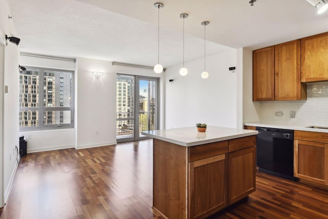 kitchen featuring dishwasher, hanging light fixtures, decorative backsplash, a textured ceiling, and dark hardwood / wood-style flooring