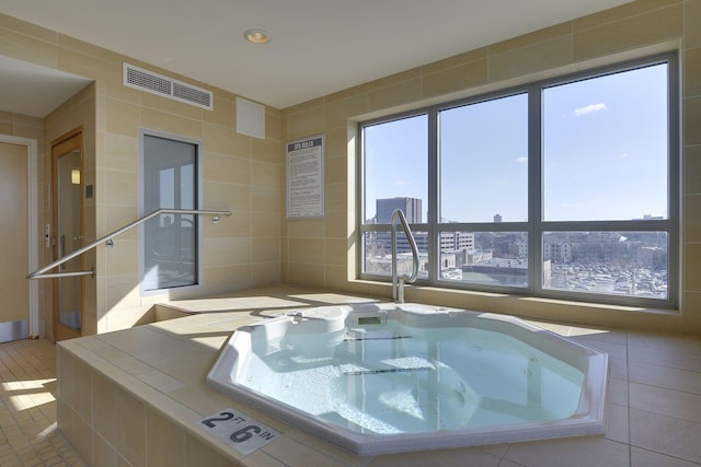 bathroom featuring tile patterned flooring and tile walls