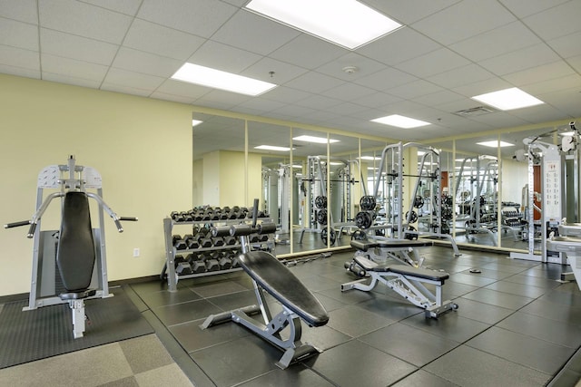 exercise room featuring a paneled ceiling