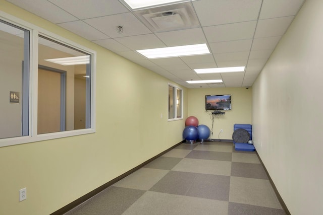 workout room with a paneled ceiling