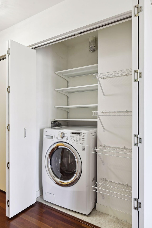 laundry area with dark hardwood / wood-style floors and washer / dryer