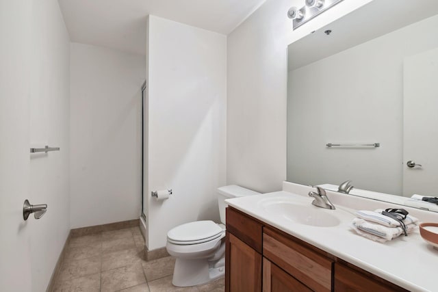 bathroom with tile patterned floors, vanity, toilet, and an enclosed shower