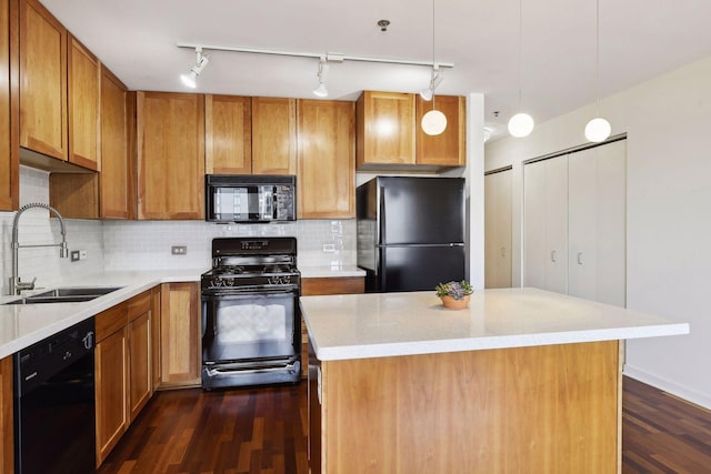 kitchen featuring dark hardwood / wood-style flooring, sink, a center island, and black appliances