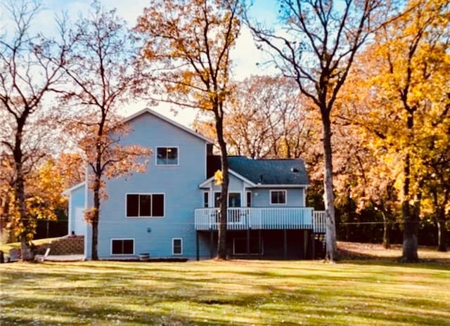 back of house with a lawn and a deck