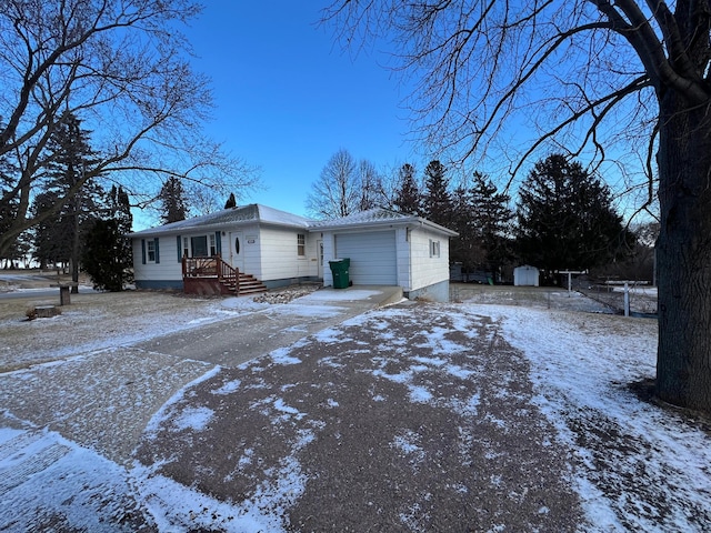 view of snow covered exterior featuring a garage