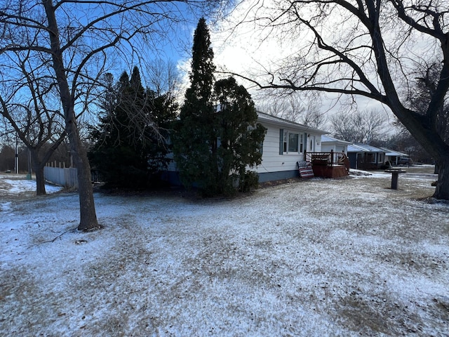 snow covered property featuring a deck