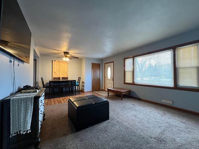 carpeted living room featuring ceiling fan