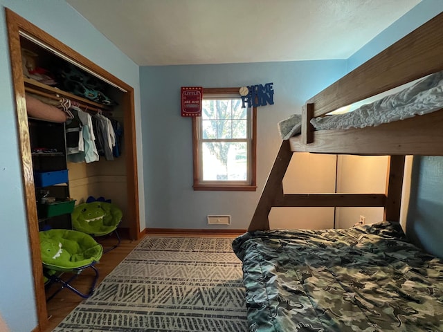 bedroom with wood-type flooring and a closet