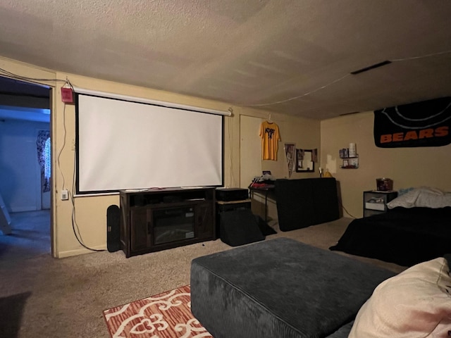 carpeted home theater room with a textured ceiling