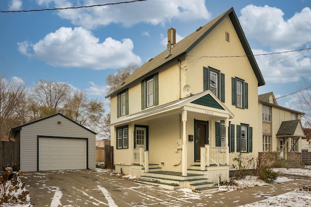 view of front of house featuring a porch, a garage, and an outdoor structure