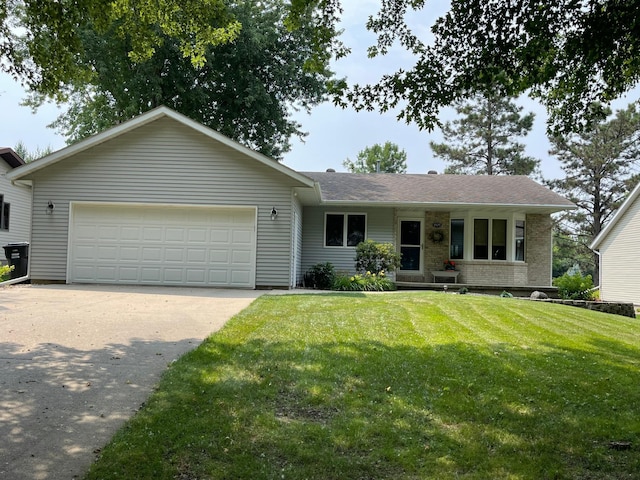 single story home featuring a garage and a front lawn