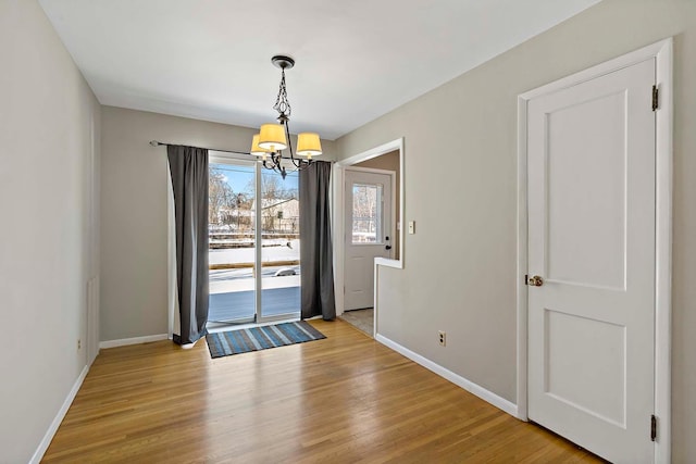 interior space featuring light hardwood / wood-style flooring and a chandelier