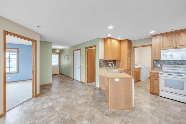 kitchen with kitchen peninsula, decorative backsplash, white appliances, a textured ceiling, and sink