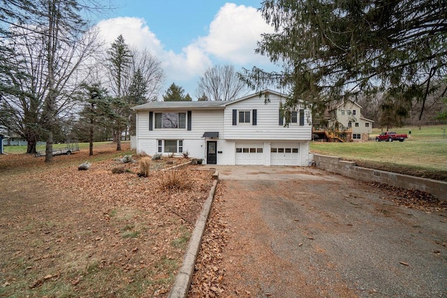 split foyer home featuring a front yard and a garage