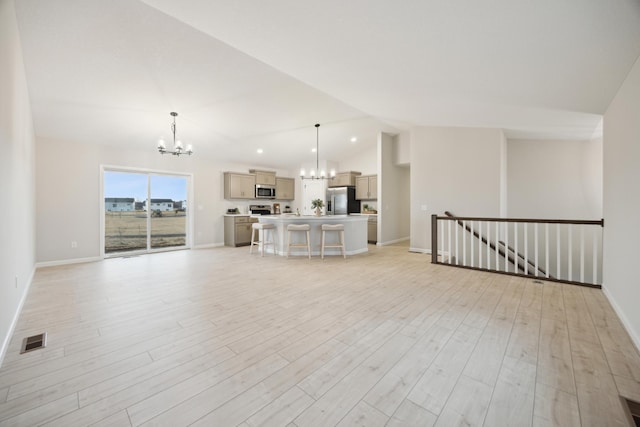 unfurnished living room featuring lofted ceiling, visible vents, baseboards, light wood-type flooring, and an inviting chandelier