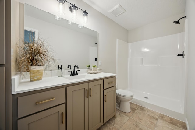 bathroom with toilet, visible vents, walk in shower, and vanity