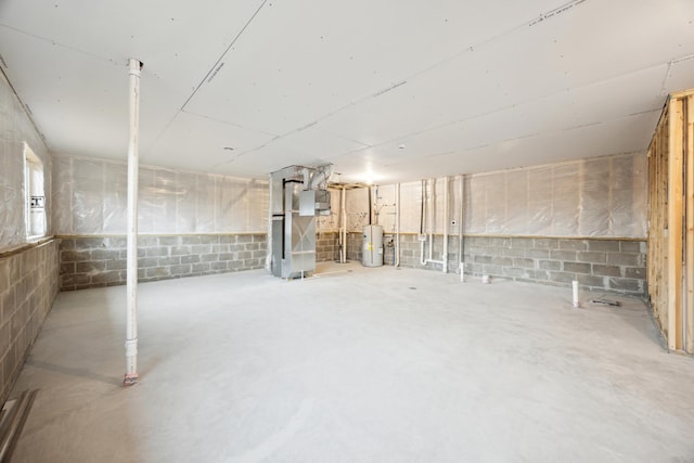 unfinished basement with heating unit and water heater