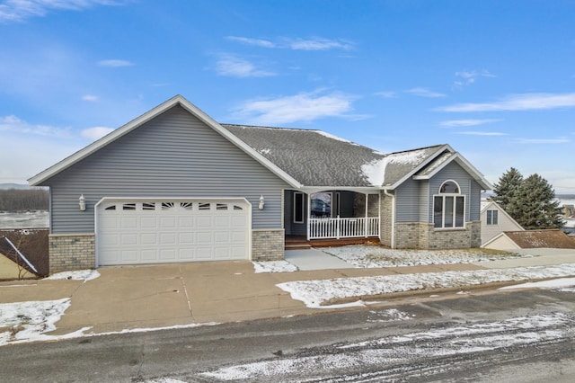 view of front of house featuring covered porch and a garage