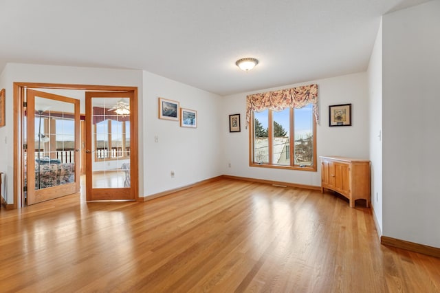 empty room with light hardwood / wood-style flooring