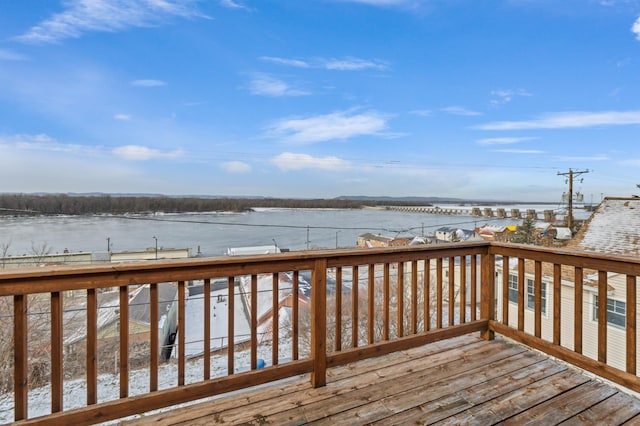 snow covered deck with a water view