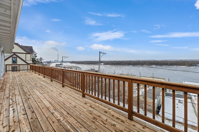 snow covered deck featuring a water view