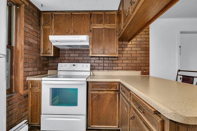 kitchen featuring white electric range oven, crown molding, baseboard heating, and brick wall