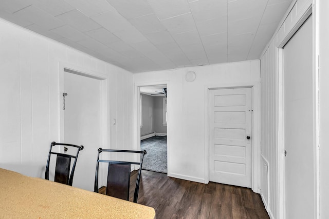 dining space featuring dark hardwood / wood-style floors, ceiling fan, and a baseboard heating unit