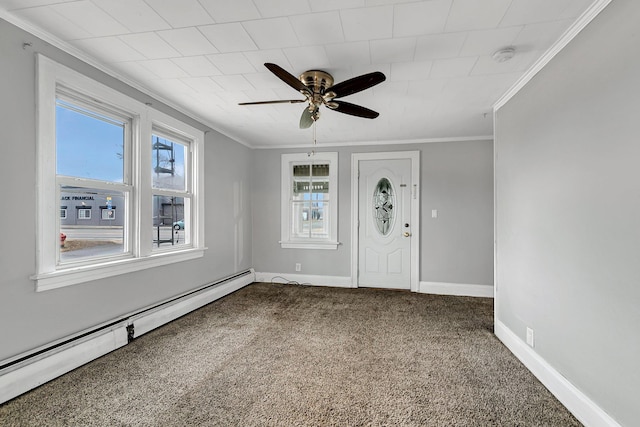 foyer entrance with baseboard heating, ceiling fan, carpet flooring, and ornamental molding