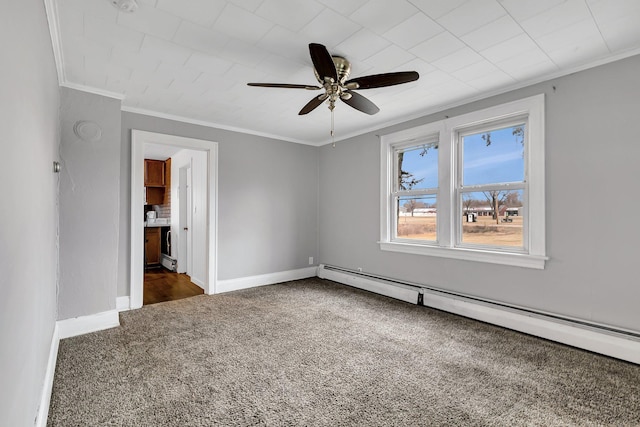 carpeted empty room with ceiling fan, crown molding, and a baseboard heating unit