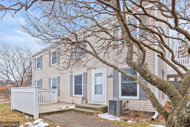 rear view of property featuring cooling unit