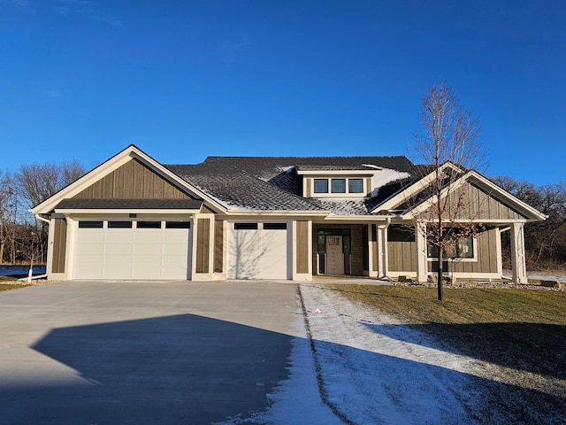 view of front of house with driveway, board and batten siding, and an attached garage