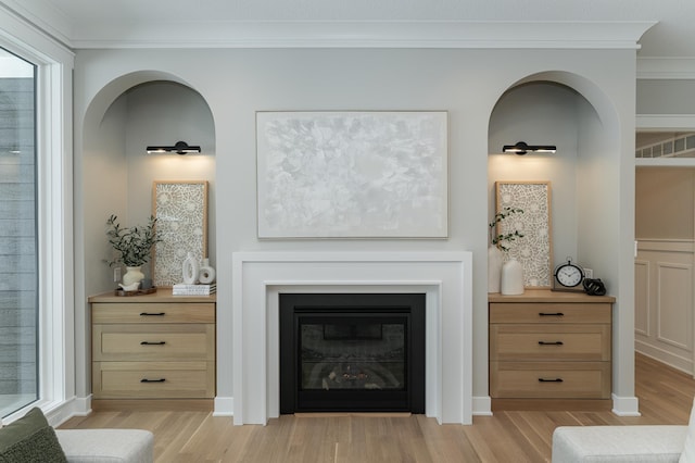 details with crown molding, baseboards, wood finished floors, and a glass covered fireplace