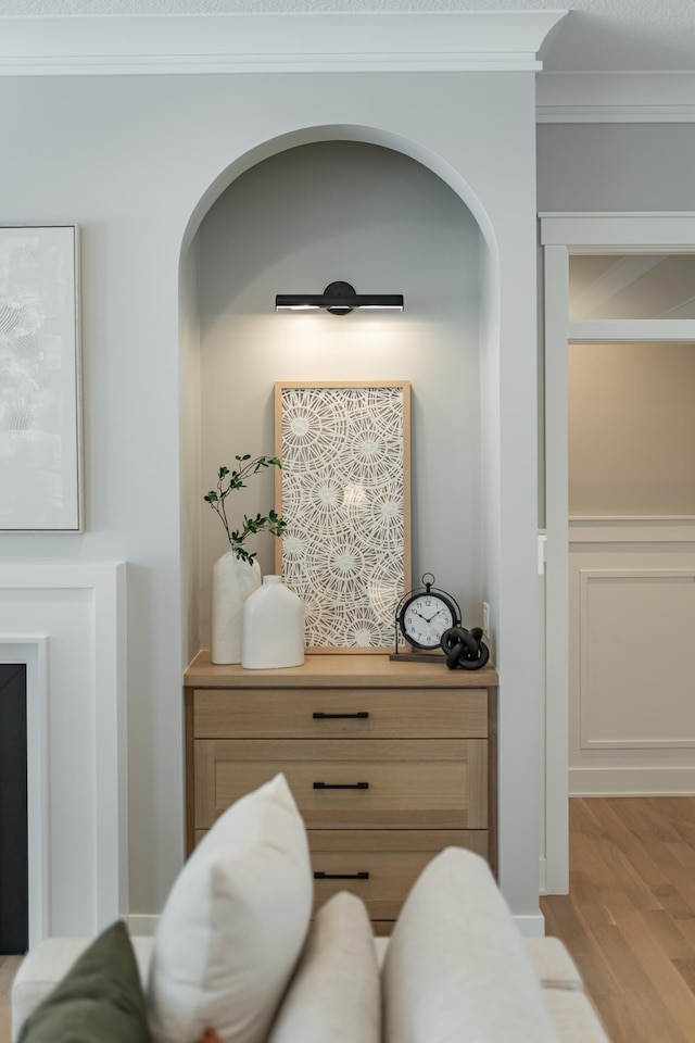 interior details with ornamental molding and wood finished floors