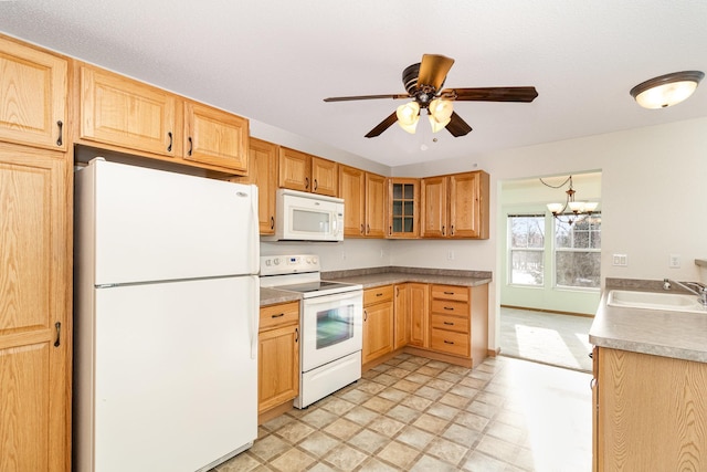 kitchen with ceiling fan with notable chandelier, white appliances, and sink