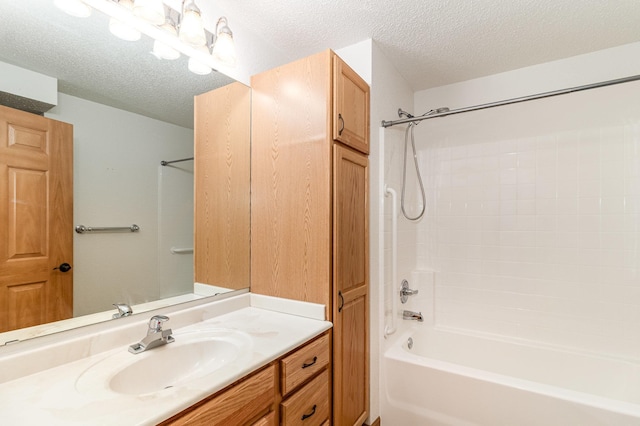 bathroom with vanity, shower / bathtub combination, and a textured ceiling