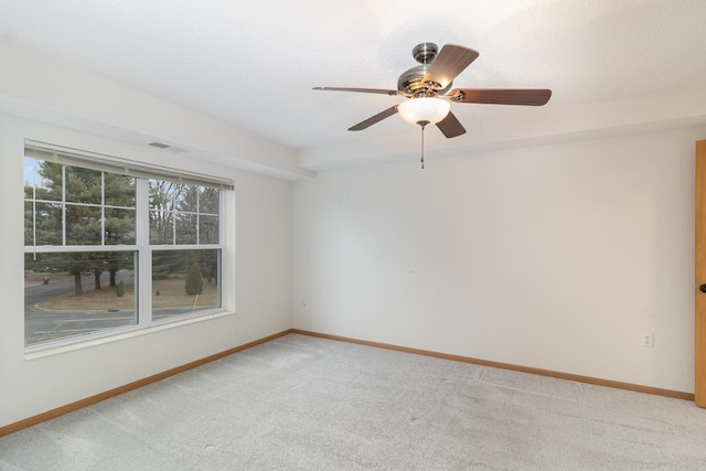 spare room featuring ceiling fan and carpet flooring