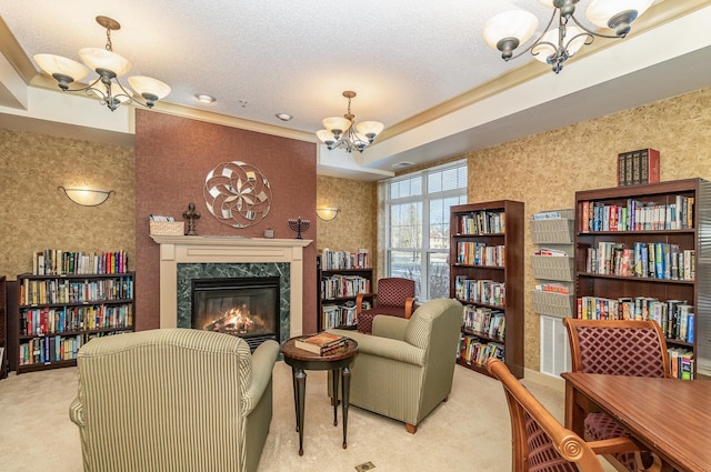 carpeted living room featuring a raised ceiling, a high end fireplace, a textured ceiling, and an inviting chandelier