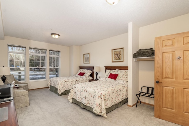 carpeted bedroom featuring a textured ceiling