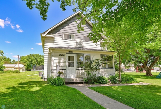 view of property featuring a front yard and a trampoline